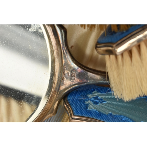 81 - A CASED SILVER AND BLUE GUILLOCHE ENAMEL VANITY SET, comprising of a hand held mirror, hair brush, t... 