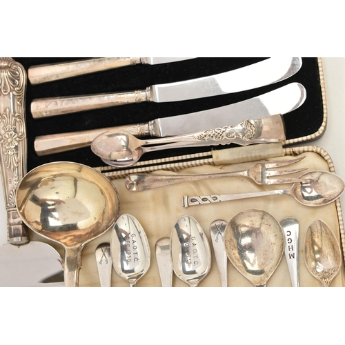 82 - A SELECTION OF SILVER CUTLERY, to include a Georgian fiddle pattern ladle, engraved crest to the ter... 