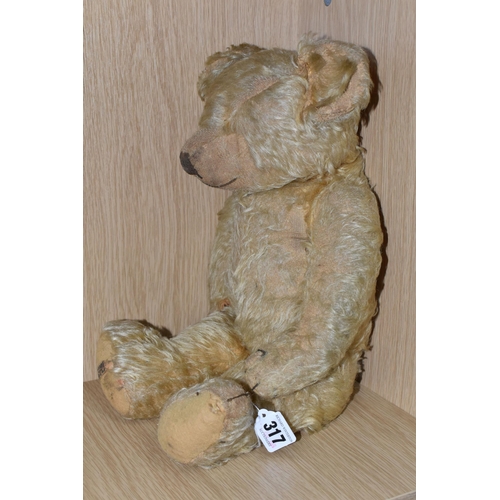 317 - A 1930'S MERRYTHOUGHT GOLDEN PLUSH TEDDY BEAR, one amber and black glass eye (other missing), shaved... 