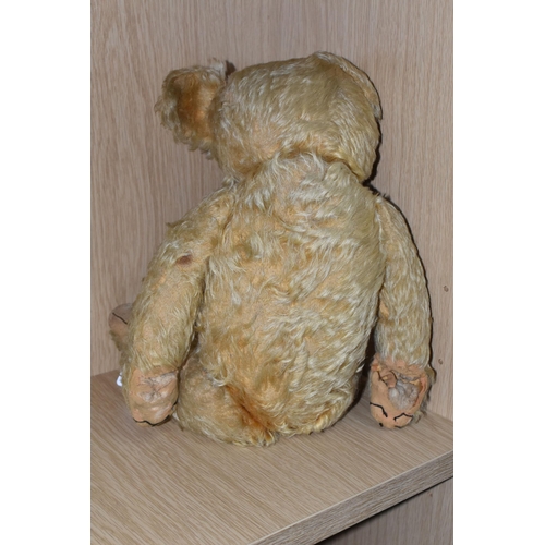 317 - A 1930'S MERRYTHOUGHT GOLDEN PLUSH TEDDY BEAR, one amber and black glass eye (other missing), shaved... 