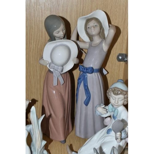 336 - A GROUP OF SIX LLADRO FIGURES AND ONE NAO FIGURE, comprising Trying on a Straw Hat, model no 5011, s... 