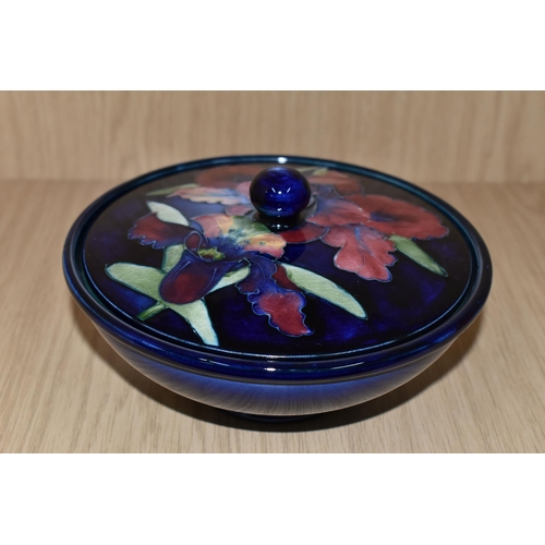 337 - A MOORCROFT POTTERY 'ORCHID' PATTERN COVERED BOWL, tube lined with pink and purple orchids on a blue... 