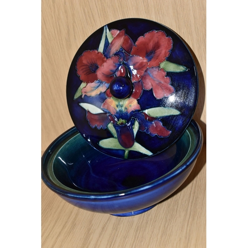 337 - A MOORCROFT POTTERY 'ORCHID' PATTERN COVERED BOWL, tube lined with pink and purple orchids on a blue... 