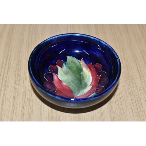 339 - A MOORCROFT POTTERY 'LEAF AND BERRIES' SMALL FOOTED BOWL, tube lined in the Leaf and Berries pattern... 