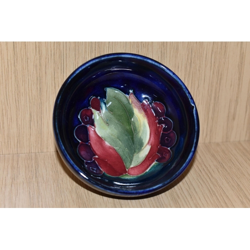 339 - A MOORCROFT POTTERY 'LEAF AND BERRIES' SMALL FOOTED BOWL, tube lined in the Leaf and Berries pattern... 