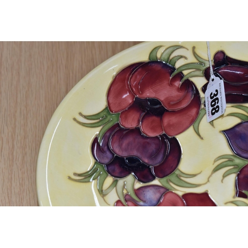 368 - A MOORCROFT POTTERY 'ANEMONE' PATTERN PLATE, tube lined with pink and purple anemones on a pale yell... 