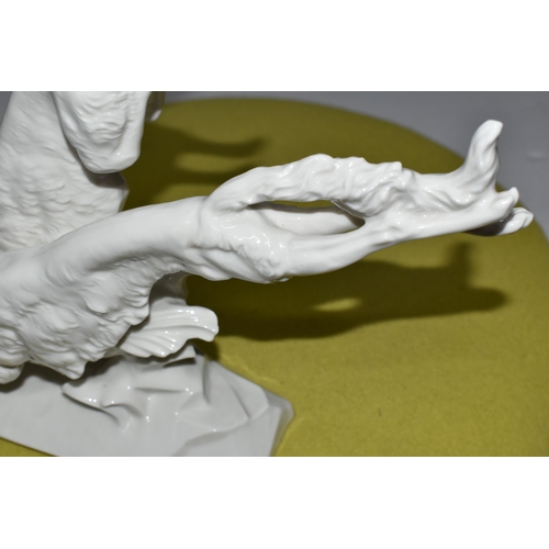 370 - A  HUTSCHENREUTHER WHITE PORCELAIN MODEL OF TWO BORZOI DOGS LEAPING OVER A ROCKY OUTCROP, designed b... 