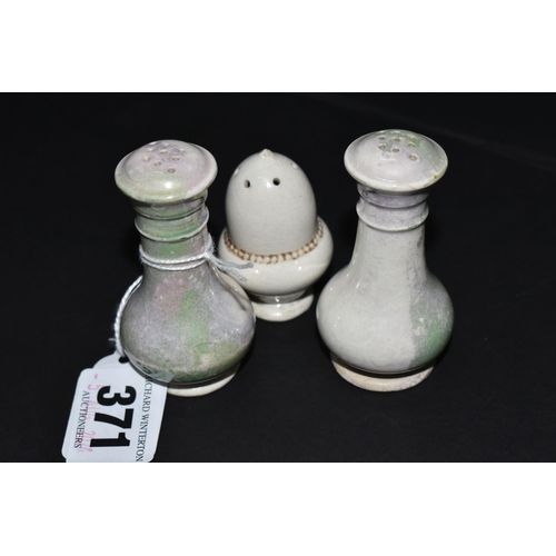 371 - THREE MOORCROFT POTTERY PEPPER POTS, one of acorn form, the other two with the remains of a green-bl... 