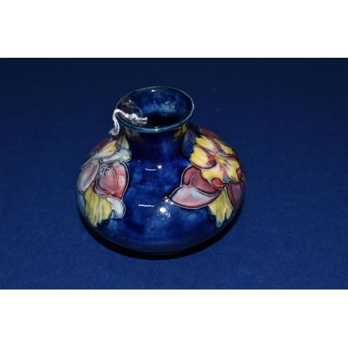 373 - A MOORCROFT POTTERY 'COLUMBINE' PATTERN VASE, of squat form, tube lined with yellow, pink and purple... 