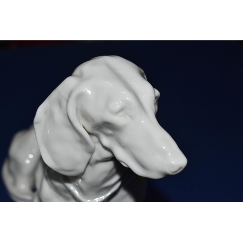 377 - A GROUP OF THREE NYMPHENBURG WHITE PORCELAIN MODELS OF DOGS, comprising a resting German Shepherd de... 