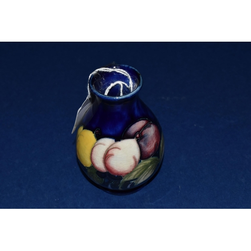 387 - A MOORCROFT POTTERY 'WISTERIA' PATTERN VASE, of small ovoid form, tube lined with purple, pink and y... 