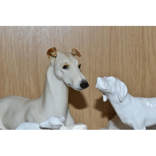 391 - A GROUP OF SIX GERMAN WHITE PORCELAIN DOGS,  comprising a Unterweissbach sleeping hound dog, signed ... 