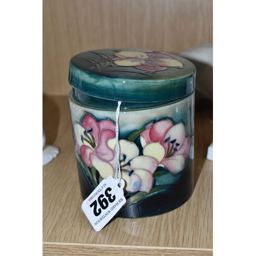 392 - A MOORCROFT POTTERY 'FREESIA' PATTERN COVERED JAR, of cylindrical form, tube lined with pale yellow ... 