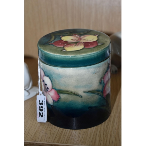 392 - A MOORCROFT POTTERY 'FREESIA' PATTERN COVERED JAR, of cylindrical form, tube lined with pale yellow ... 