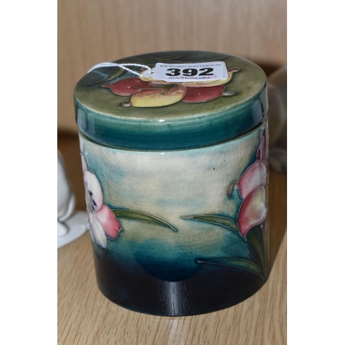 392 - A MOORCROFT POTTERY 'FREESIA' PATTERN COVERED JAR, of cylindrical form, tube lined with pale yellow ... 