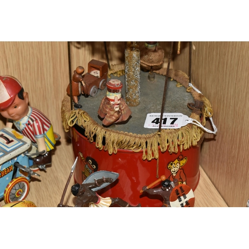 417 - A TINPLATE CLOCKWORK MUSICAL CAROUSEL, c.1930s, red painted base with transfers and canopy, wooden f... 