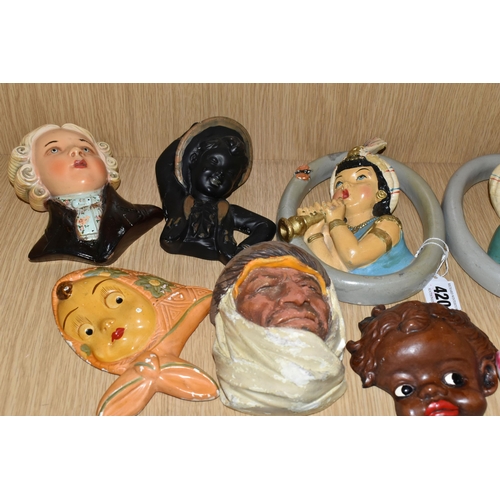 420 - A GROUP OF CHALKWARE FACE PLAQUES, to include ten face plaques and a small chalkware bust, largely m... 