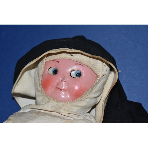 447 - A VINTAGE NURSE DOLL, painted celluloid face which has some paint loss, crush damage to nose and wea... 