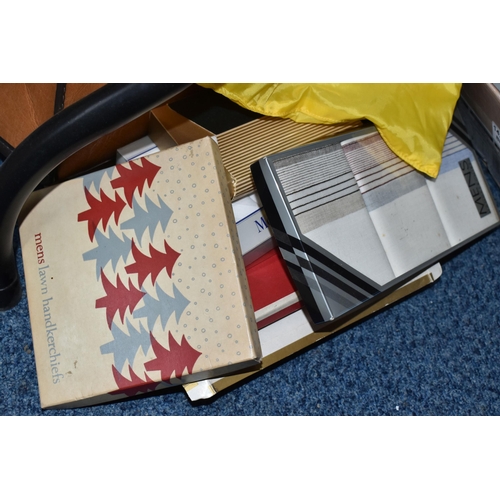 575 - SEVEN BOXES AND LOOSE CLOTHING, TABLE LINEN AND TWO  VINTAGE FAUX LEATHER SUITCASES, to include a pa... 