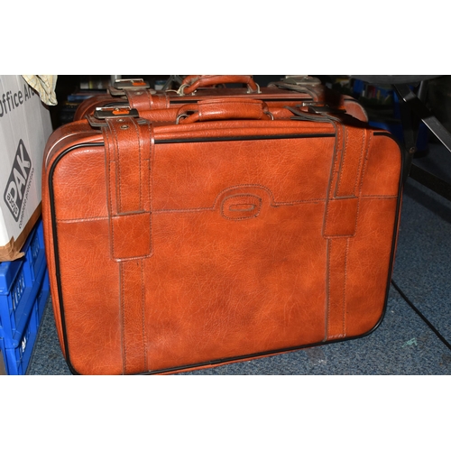 575 - SEVEN BOXES AND LOOSE CLOTHING, TABLE LINEN AND TWO  VINTAGE FAUX LEATHER SUITCASES, to include a pa... 