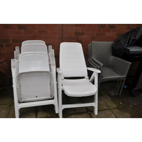 1022 - FOUR WHITE PLASTIC RECLINING GARDEN CHAIRS and three rattan style chairs with cushions (7)