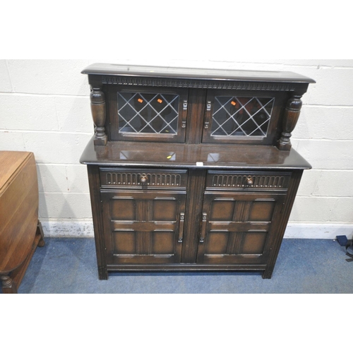 1199 - A 20TH CENTURY OAK COURT CUPBOARD, with two lead glazed doors, two drawers, above double cupboard do... 