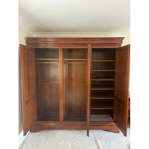 1247 - A CHERRYWOOD TRIPLE DOOR WARDROBE, the right hand door enclosing five shelves, width 194cm x depth 6... 