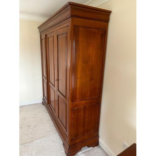 1247 - A CHERRYWOOD TRIPLE DOOR WARDROBE, the right hand door enclosing five shelves, width 194cm x depth 6... 