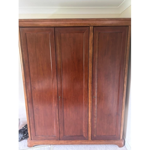 1248 - WILLIS AND GAMBIER, A CHERRYWOOD TRIPLE DOOR WARDROBE, the right hand door enclosing three shelves, ... 