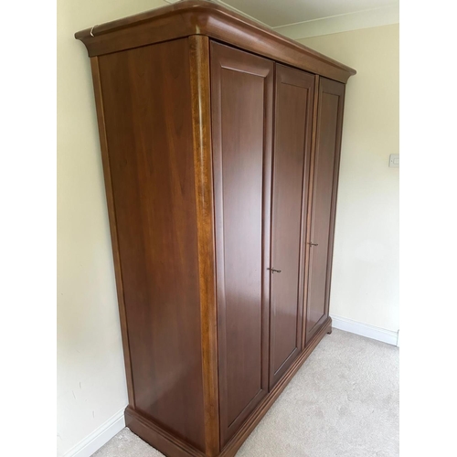 1248 - WILLIS AND GAMBIER, A CHERRYWOOD TRIPLE DOOR WARDROBE, the right hand door enclosing three shelves, ... 