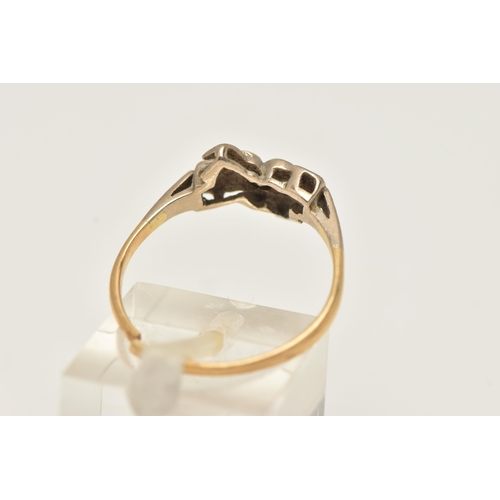 11 - A YELLOW METAL DIAMOND RING, set with a central round brilliant cut diamond, illusion set in a heart... 