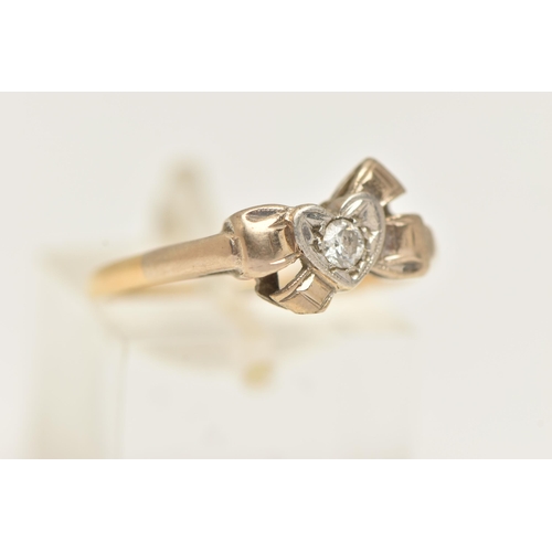 11 - A YELLOW METAL DIAMOND RING, set with a central round brilliant cut diamond, illusion set in a heart... 