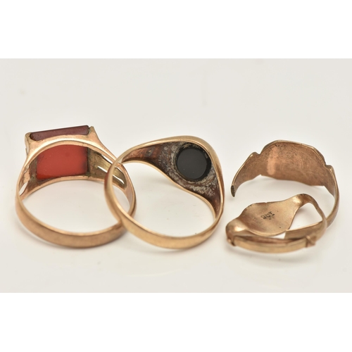 16 - FOUR RINGS, all of signet design, one set with an oval onyx panel, one with a square chalcedony pane... 