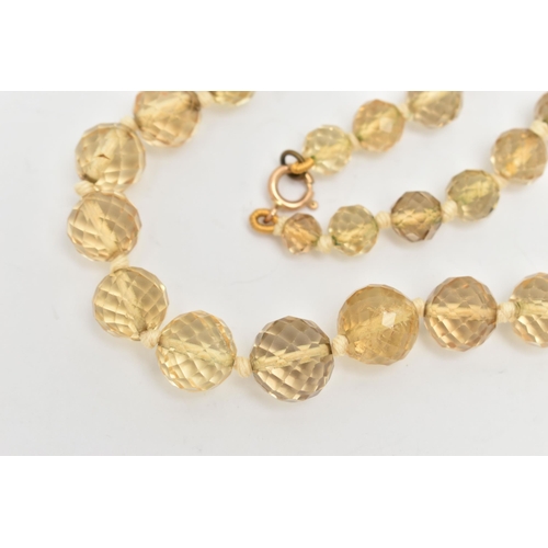 18 - A FACETED CITRINE BEAD NECKLACE, faceted round graduated citrine beads, individually knotted on a co... 