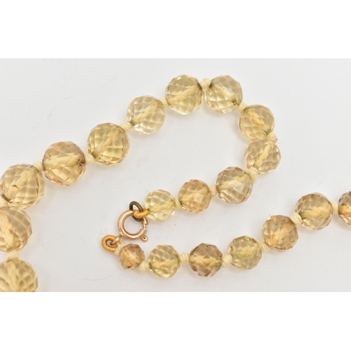 18 - A FACETED CITRINE BEAD NECKLACE, faceted round graduated citrine beads, individually knotted on a co... 