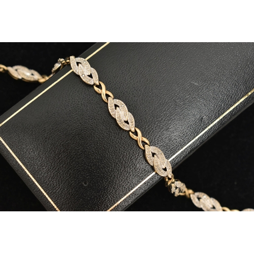 19 - A 9CT GOLD DIAMOND SET LINE BRACELET, designed as a row of nine interlocking links each set with two... 