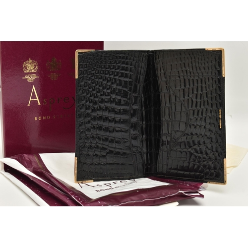 26 - AN 'ASPREY LONDON' 9CT GOLD MOUNTED CROCODILE SKIN WALLET, of a rectangular form, displaying the ini... 