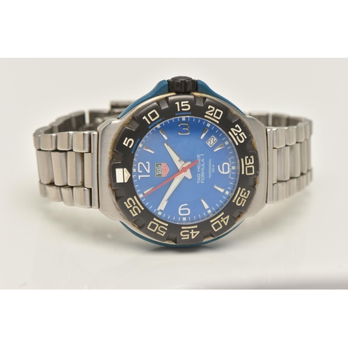 30 - A TAG HEUER FORMULA 1 QUARTZ WATCH, the blue face with Arabic and baton marker's, a date dial, lumin... 