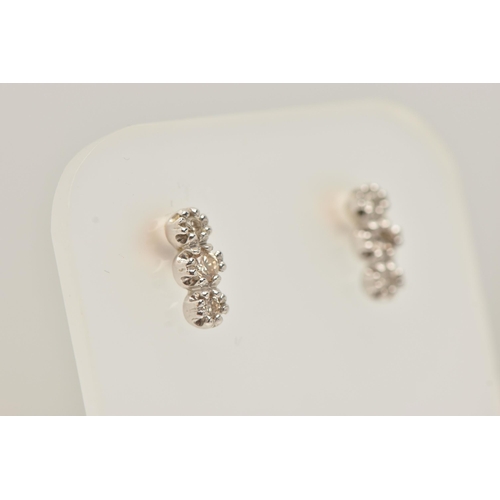 35 - A PAIR OF 18CT GOLD DIAMOND EARRINGS, each designed as a vertical line of three brilliant cut diamon... 