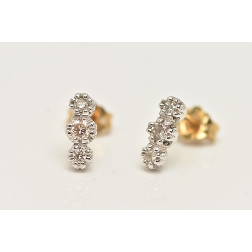 35 - A PAIR OF 18CT GOLD DIAMOND EARRINGS, each designed as a vertical line of three brilliant cut diamon... 