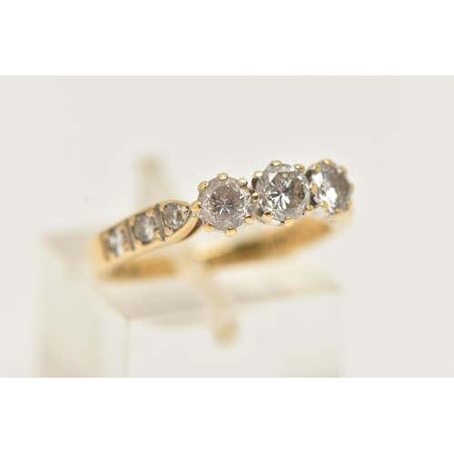 36 - AN 18CT GOLD THREE STONE DIAMOND RING, designed as three brilliant cut diamonds with three diamonds ... 