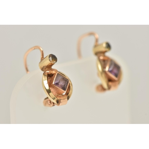 39 - A PAIR OF GEM SET EARRINGS, each designed with a central diamond shape purple gem, set above with a ... 