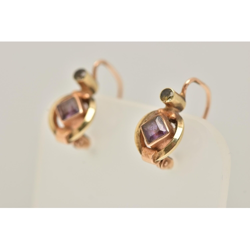 39 - A PAIR OF GEM SET EARRINGS, each designed with a central diamond shape purple gem, set above with a ... 