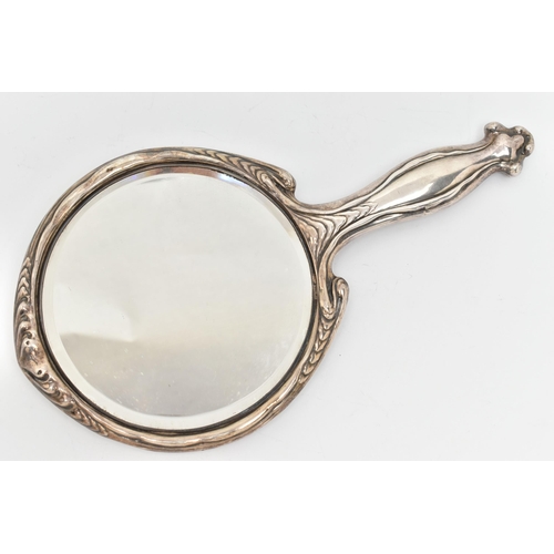 54 - AN EARLY 20TH CENUTRY SILVER MIRROR, the circular handheld mirror with embossed floral and scrolling... 