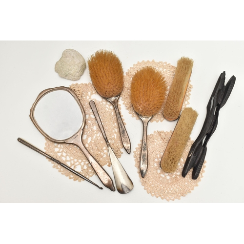 65 - A GEORGE V SILVER VANITY SET, a seven piece vanity set to include a mirror, two hair brushes, two cl... 