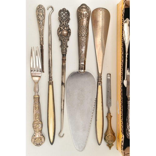 67 - A SELECTION OF SILVER HANDLED ITEMS, mainly button hooks, also two shoe horns, a cake slice, most wi... 