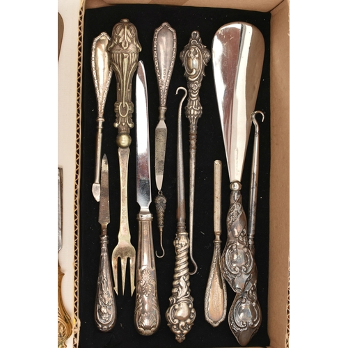 67 - A SELECTION OF SILVER HANDLED ITEMS, mainly button hooks, also two shoe horns, a cake slice, most wi... 