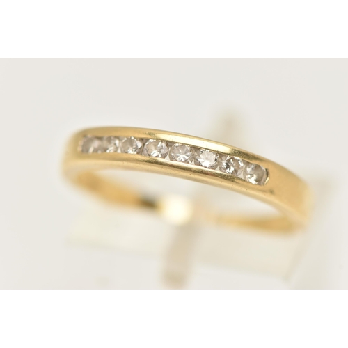 123 - A YELLOW METAL DIAMOND BAND RING, eight round brilliant cut diamonds, channel set in yellow metal, a... 