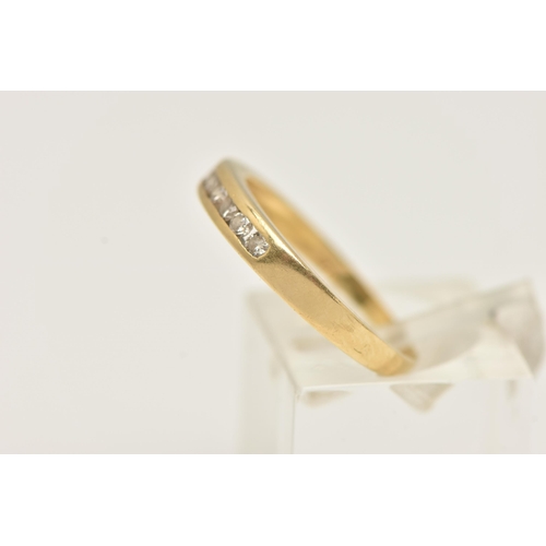 123 - A YELLOW METAL DIAMOND BAND RING, eight round brilliant cut diamonds, channel set in yellow metal, a... 