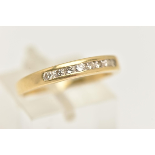 123 - A YELLOW METAL DIAMOND BAND RING, eight round brilliant cut diamonds, channel set in yellow metal, a... 